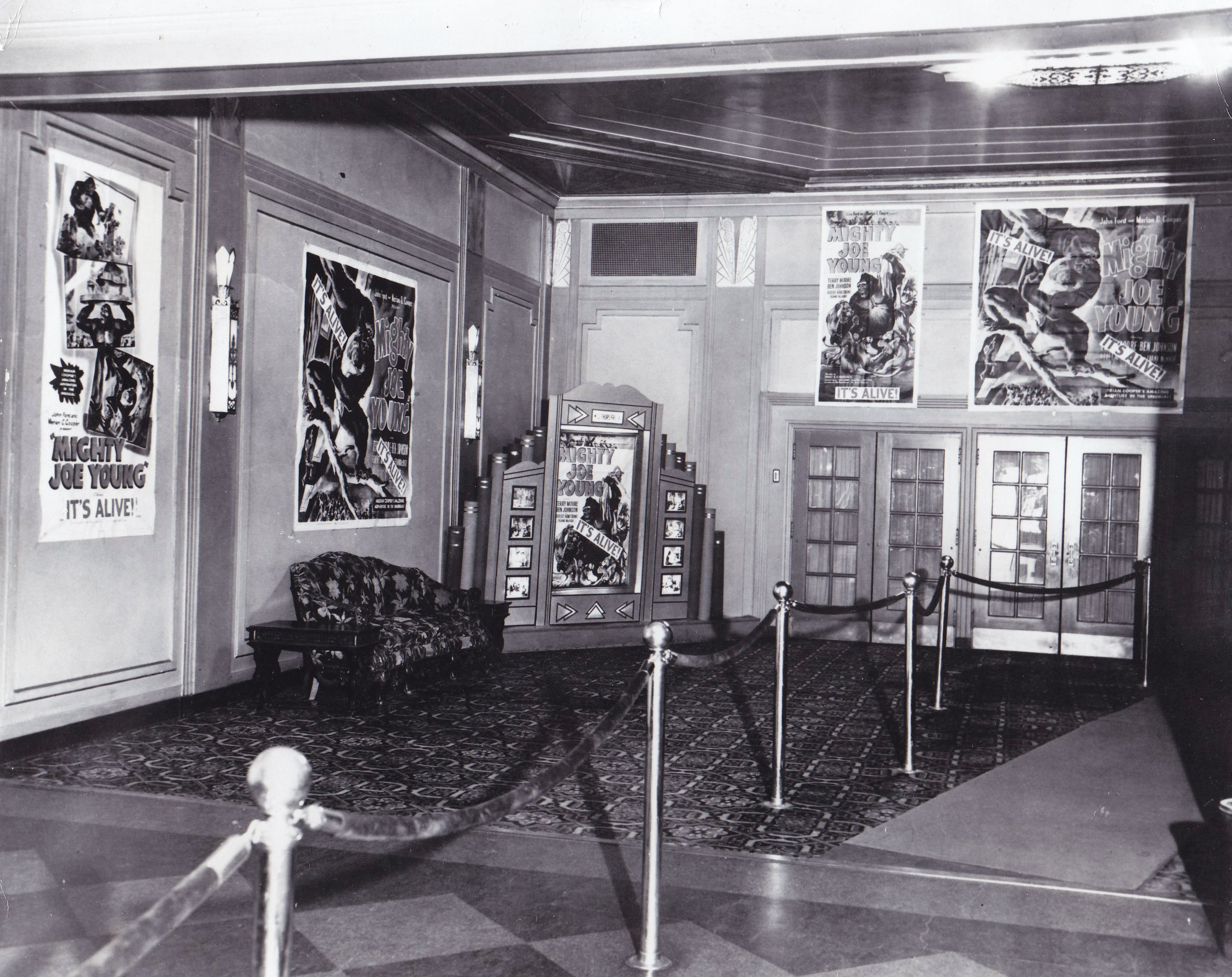 Historic image of the Flynn lobby with movie posters hanging.
